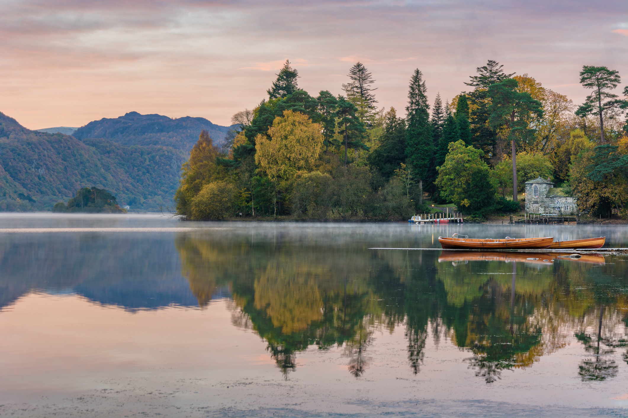 Sunrise over Derwentwater and canoes.